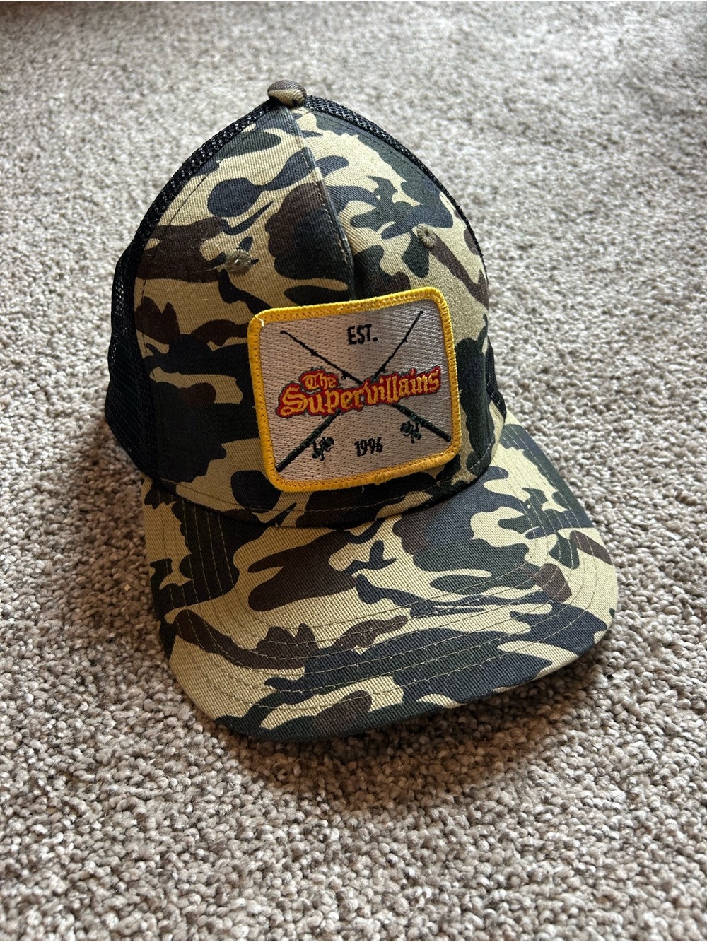 The supervillains(band) Camo Trucker Hat with Yellow Patch